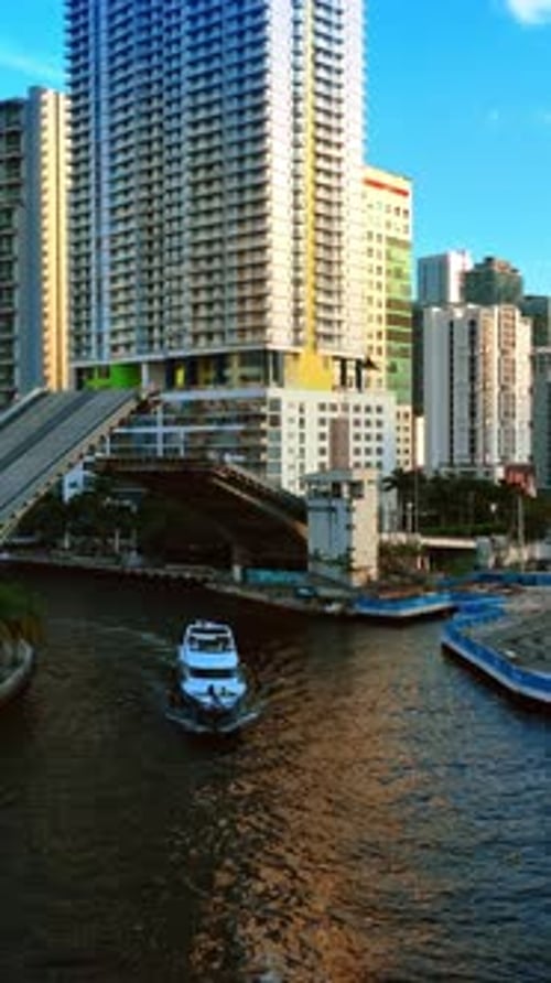 Yacht sailing under the drawbridge and another motor boat approaches the bridge.