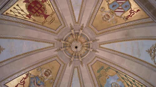 ornate church dome ceiling with gold heraldic symbols and central design