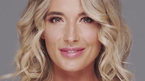 Studio Portrait of Young and Beautiful Blond Woman Over Grey Background Skin Care and Wellness