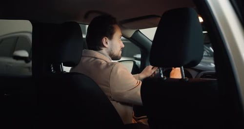 Customer is Sitting Inside New Car While Shopping in Modern Showroom Footage From the Backseat