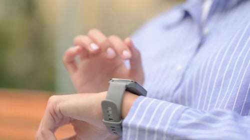Close up of Hispanic Woman Using Smart Watch Outdoor