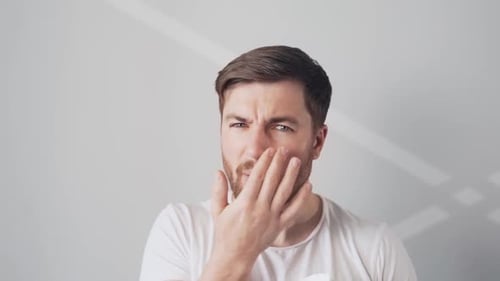 Man with Beard Applying Product to Face