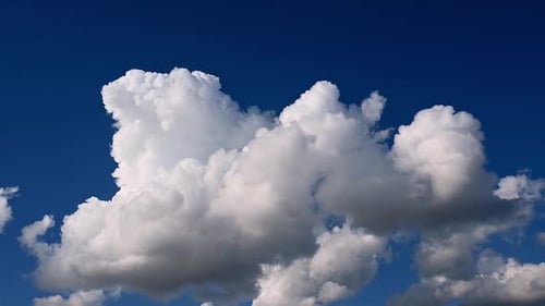 Blue sky white clouds. Fluffy fluffy white clouds. Cumulus cloud cloudscape time-lapse. Summer blue