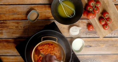 Mixing Tomatoes in Strainer with Cooking Ingredients