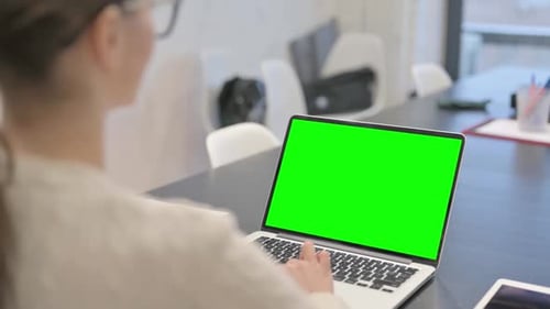 Woman Using Laptop with Green Screen