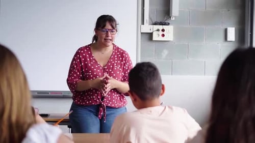 High School Teacher Explaining Lesson to Students in Classroom