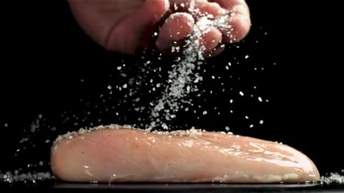 Seasoning Raw Poultry with Salt, Close Up
