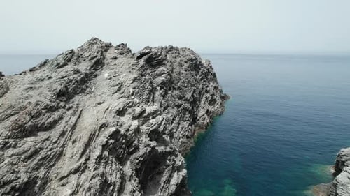 (Top down view) Aerial view fly over drone over sea cliff with powerful sea waves. Beach sand in Sar