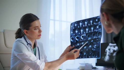 Doctor Discussing Brain Scans with Patient in Office