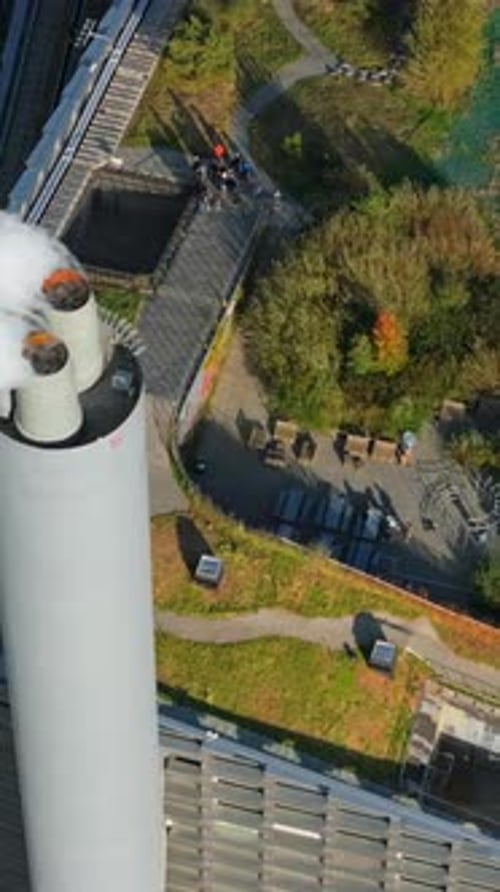 Aerial drone view of CopenHill artificial ski slope on the roof of an energy plant. Vertical