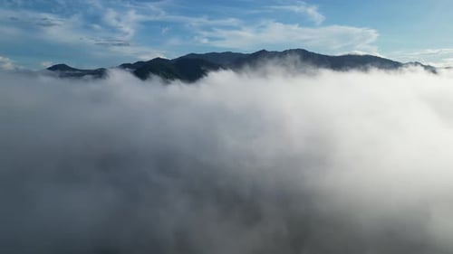 Aerial View of Clouds and Distant Mountains