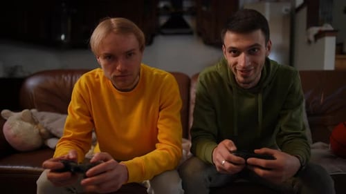 Young Man Winning Friend Playing Video Game Comforting Guy Tapping Shoulder Front View Positive