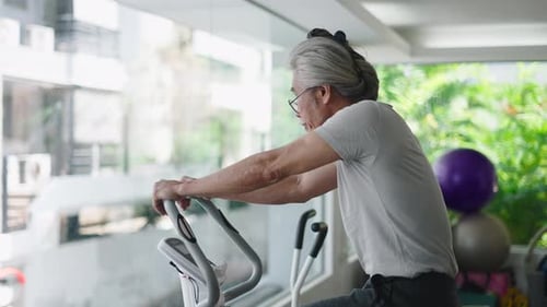 Senior Adult Exercises on Elliptical Indoors