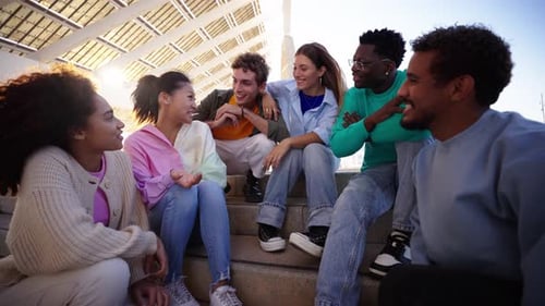 Crowd Happy Multicultural Young People are Sitting on Stairs Enjoying Laughing and Talking Outdoors