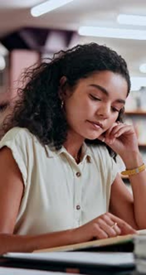 Woman, student and study with reading book in library for knowledge, research