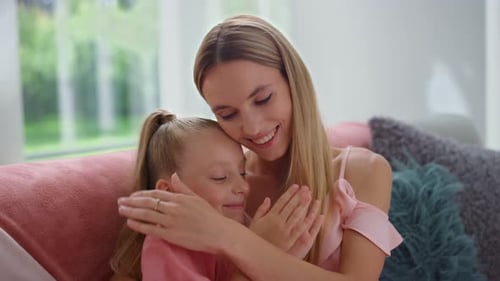 Portrait Of Joyful Woman And Girl Talking In Living Room. Happy Mother And Daughter Clapping Hand...
