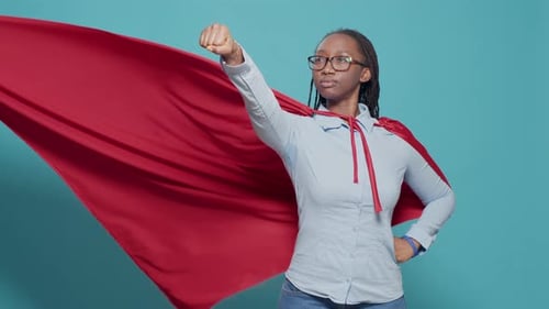 Portrait of Superhero with Flying Red Cape on Camera