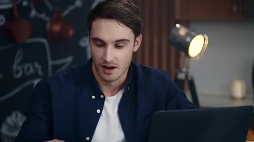 Man on Laptop Having Video Call with Coffee