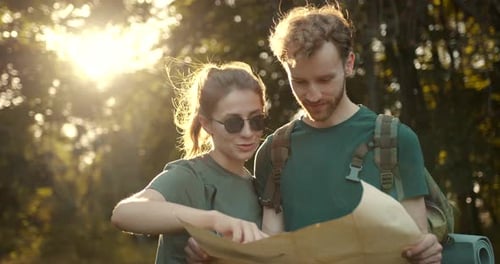 Couple Planning Hike with Map in Forest