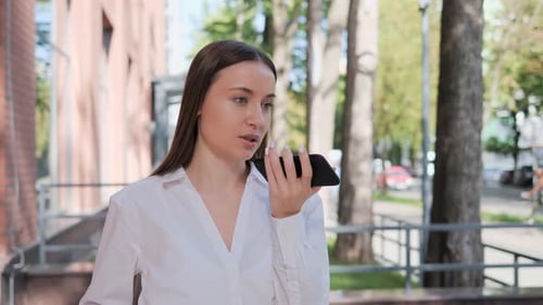 Business Woman Leaving a Voice Message on Mobile