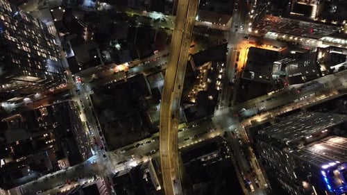 Aerial Views Capture Glowing Streets and Buildings in New York City at Night Cars Traverse Busy