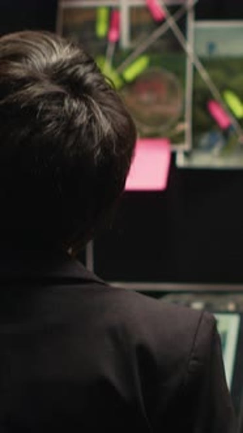 Focused Woman Analyzing Data in a Dim Office