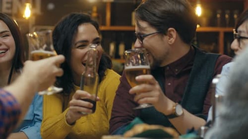 Company of Friends Having Fun in the Bar, They Drink, Talk and Joke Around. Beautiful Young People