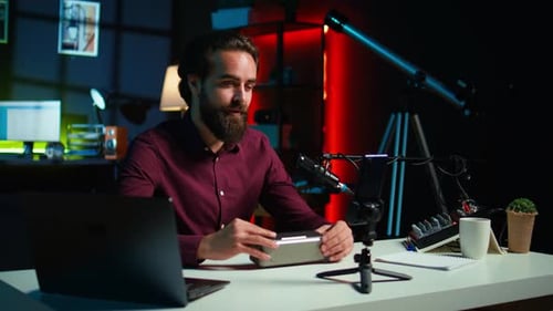 Man Reviews Bluetooth Speaker in Colorful Home Studio