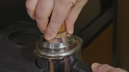 Hands Tamping Espresso Coffee Grounds Close Up