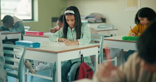 Writing, children and students in classroom for exam, test and knowledge in elementary school