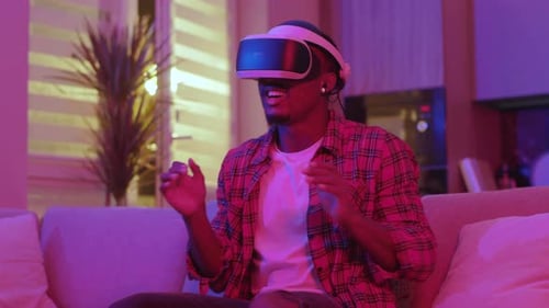 Man Excitedly Playing a VR Game at Home