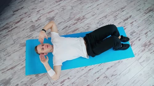 Young Adult Doing Sit Ups on Yoga Mat