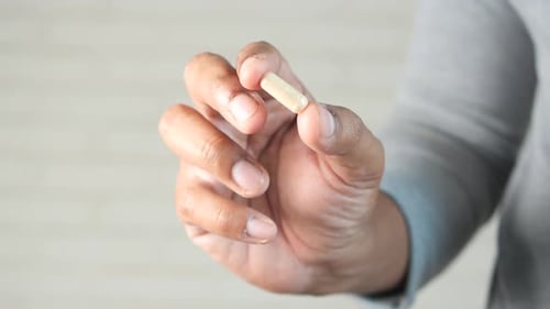 Close Up of Man Hand Holding Pills with Copy Space