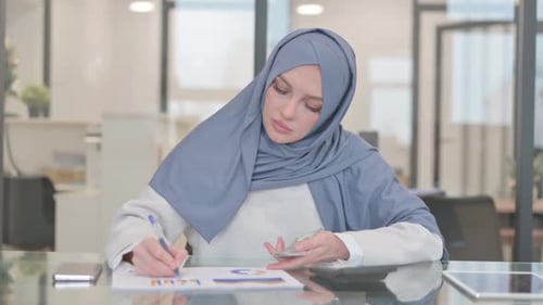 Woman in Hijab Working with Money in Office