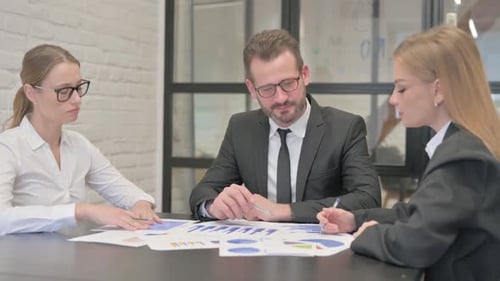 Business Team Analyzing Data Together