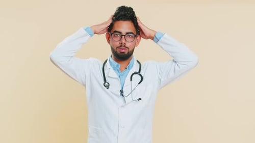 Young Doctor Gesturing and Thinking, Medium Shot