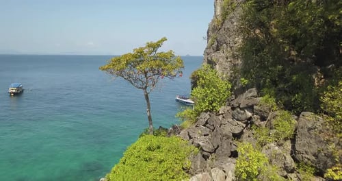 Aerial View of Steep Cliffs Over Sea and Boat Anchored Near Coast. Typical Nature Scenery in Krabi P