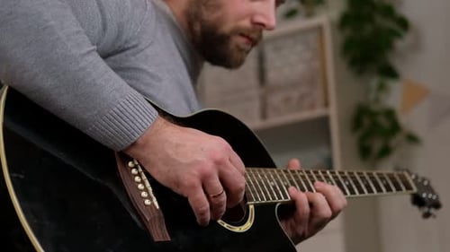 Adult Man Playing Acoustic Guitar Close Up