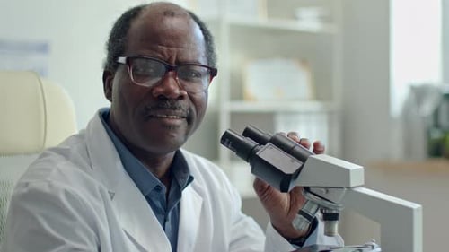 Senior Doctor with Microscope