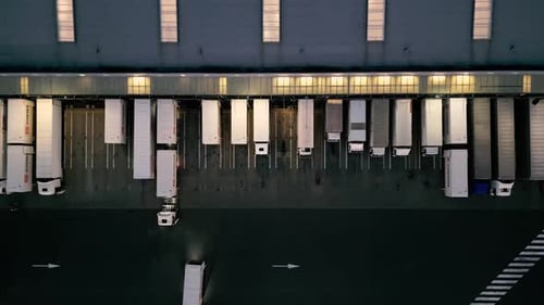 Night aerial view of a warehouse of goods for online stores. Logistic center in the industrial area