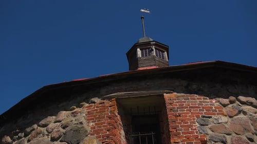 An outdoor panning view of sky and fortress tower with the fabulous stone wall. Russia.