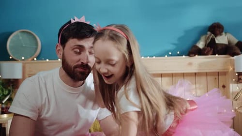 Closeup Cute View Young Girl Princess Putting a Crown on Hher Father's Head Little Daughter Dressing