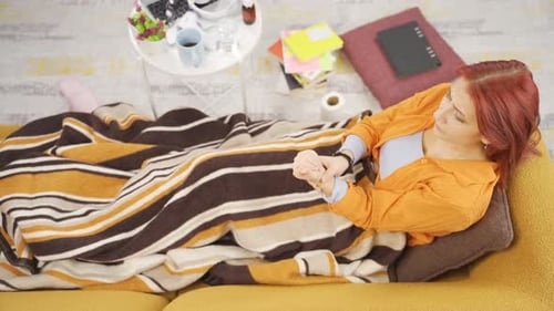 Woman Resting on Couch Taking Medicine at Home