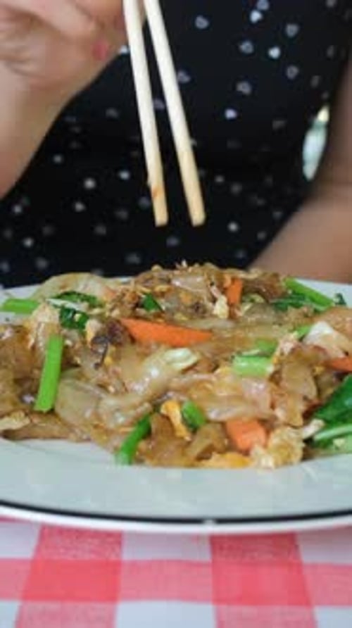 Close Up Noodles on a Plate With Chopsticks