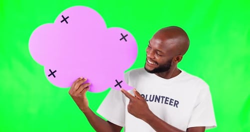 Speech bubble, pointing and a black man volunteer on green screen in studio for social media