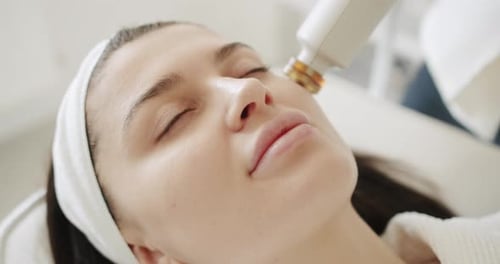 Woman Receiving Facial Skin Treatment in Beauty Salon