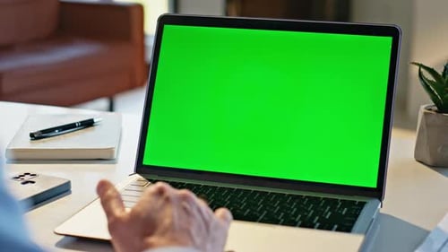 Laptop with Green Screen Used At Desk