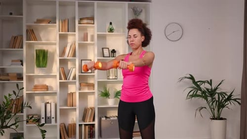Woman Doing Arm Exercises with Dumbbells at Home