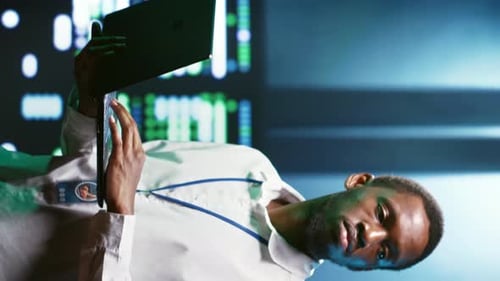 Man Looking at Tablet in a Futuristic Workplace