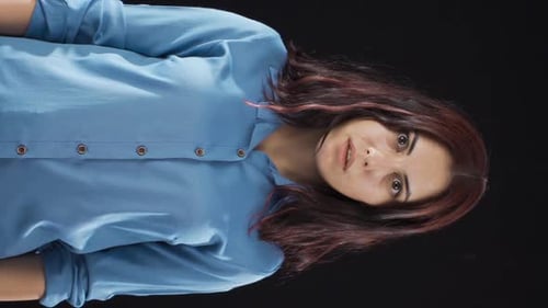 Vertical Video of Psychologically troubled woman looking strangely at camera.